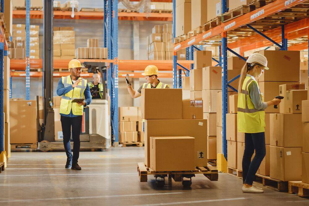 warehouse personnel working and greeting each other