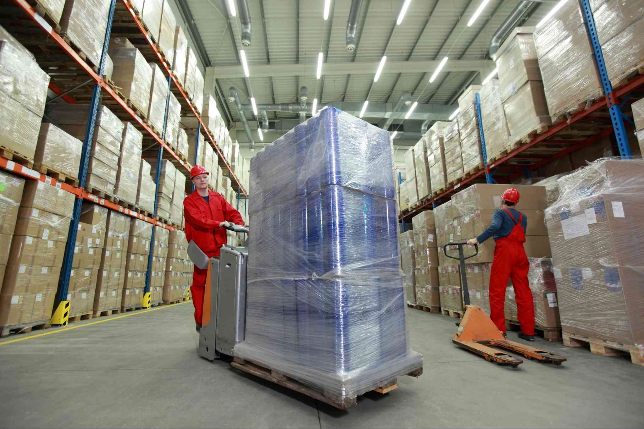 Women pushing cart with large container