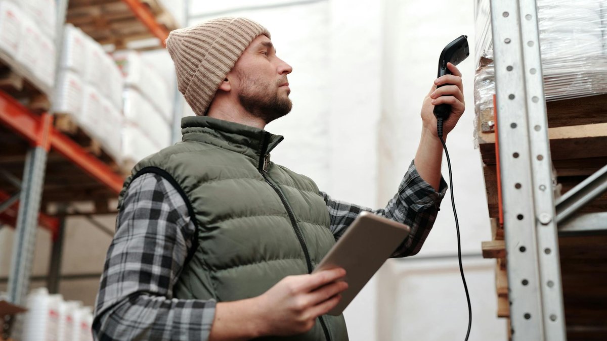 Warehouse worker scanning barcode for inventory tracking
