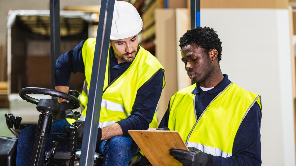 Two warehouse workers in safety vests