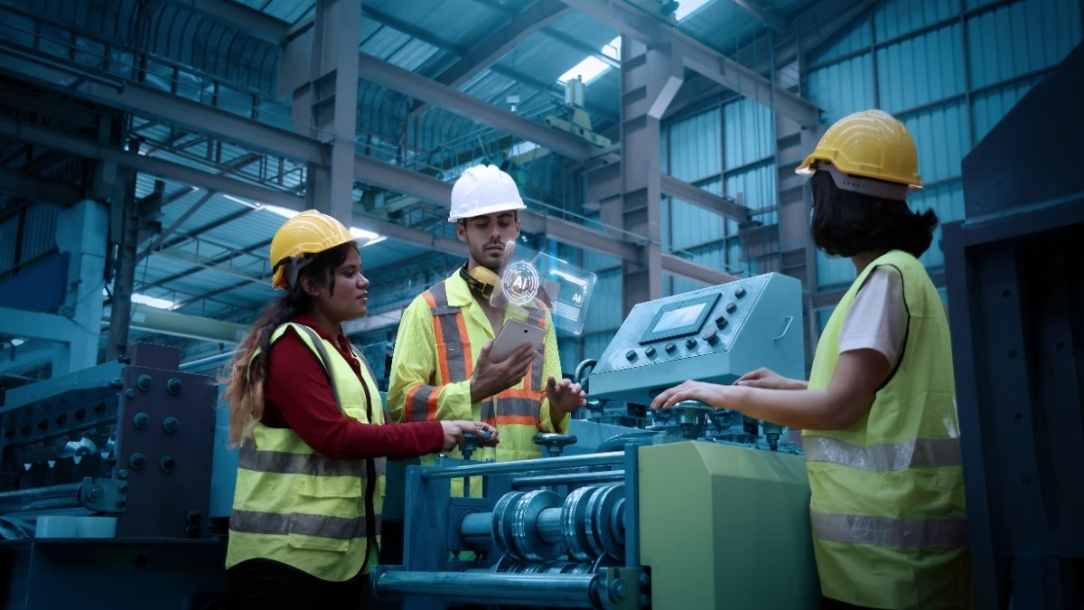 three industrial workers wearing safety helmets